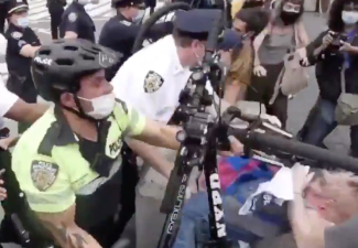 A cop used his bike to bash a protester in May 2020. Photo: File
