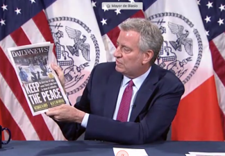 The mayor also tried to highlight the "good" news by showing the Daily News wood today.