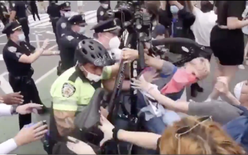 Police using their bicycles as weapons against protesters in Union Square last year. File photo