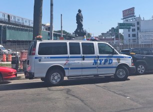 Your tax dollars at work: two officers from the 114th Precinct in Queens guard a Christopher Columbus statue around the clock. Photo: Adam Light