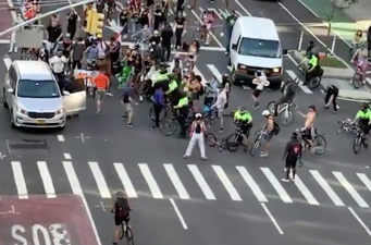 Cops on bikes plow over protesters to form a security ring around other officers throwing a protester into an unmarked van during a July protest.