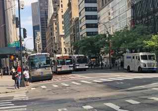 Even with two dedicated bus lanes, blocked lanes sometimes force buses into the existing car lanes on Fifth Avenue, evidence that a car-free busway is needed. Photo Adam Light