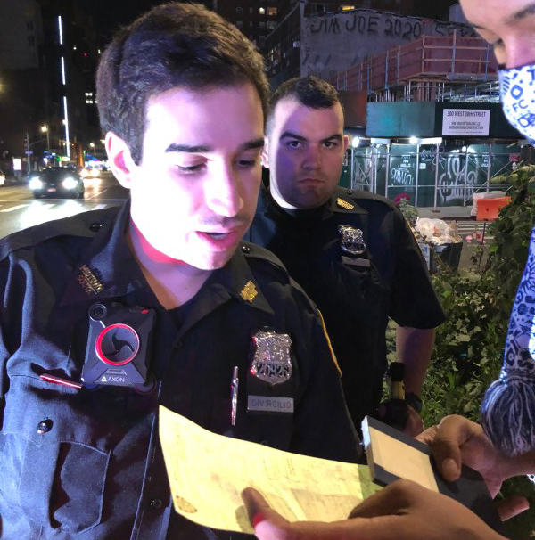 The cops writing Zoltan a ticket for not wearing a helmet on Sept. 5. Photo provided