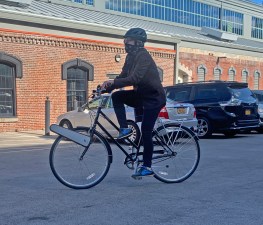 Clip attaches to the front wheel of any bike and gives an e-bike boost whenever the rider presses a button on the handlebars. Photo: Gersh Kuntzman