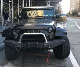 The Jeep of a Kings County District Attorney detective parked illegally on Adams Street. Photo: Julianne Cuba