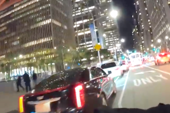 The Sixth Avenue protected bike lane, blocked by car after car on Nov. 5.