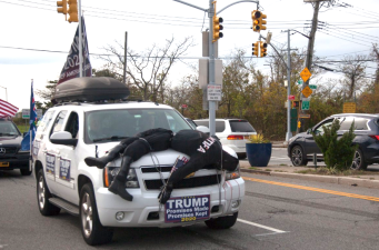 A Trump-supporter sported an effigy of a dead  Antifa activist as a hood ornament on an SUV with illegally obscured license plates in Queens on Sunday. Photo: Via Twitter