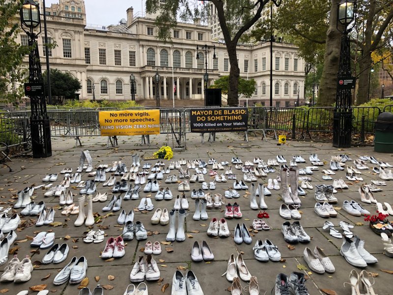 Members of Families for Safe Streets used 214 pairs of shoes on Sunday to mark the lives lost this year to traffic violence. Photo: Families for Safe Streets