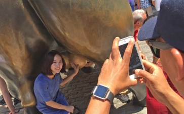 In better times, tourists are everywhere ... even touching the testicles on the Wall Street bull. File photo: Gersh Kuntzman