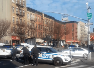 Cops at the scene on First Avenue and E. 118th Street, where the 24th cyclist was killed on Friday morning. Photo: Citizen