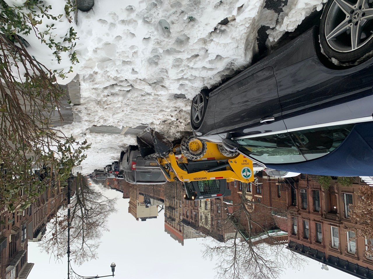 A DSNY machine tries to clean out a bike lane in Park Slope — four days after the end of this winter's first storm. Photo: Gersh Kuntzman