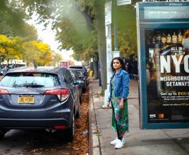 Many residents of Eastern Queens would like to get out of using cars but are stymied by the lack of transit options, Citi Bikes, and protected bike lanes, says City Council hopeful Deepti Sharma (pictured here at a bus stop in her district).