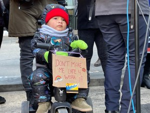 The tiniest commuter in New York rallies on Tuesday for more MTA funding. Photo: Dave Colon