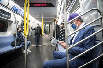 Mayor Bill de Blasio wears a blue suit and baseball cap and rides the F Train from Manhattan to Brooklyn. Wednesday, May 12, 2021.