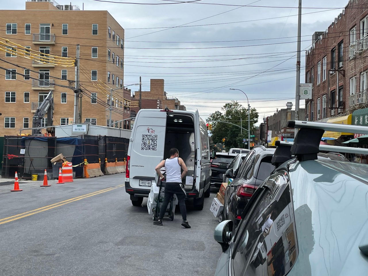 Workers double park to make a delivery, as another driver double parks in front of them. Photo: Dave Colon
