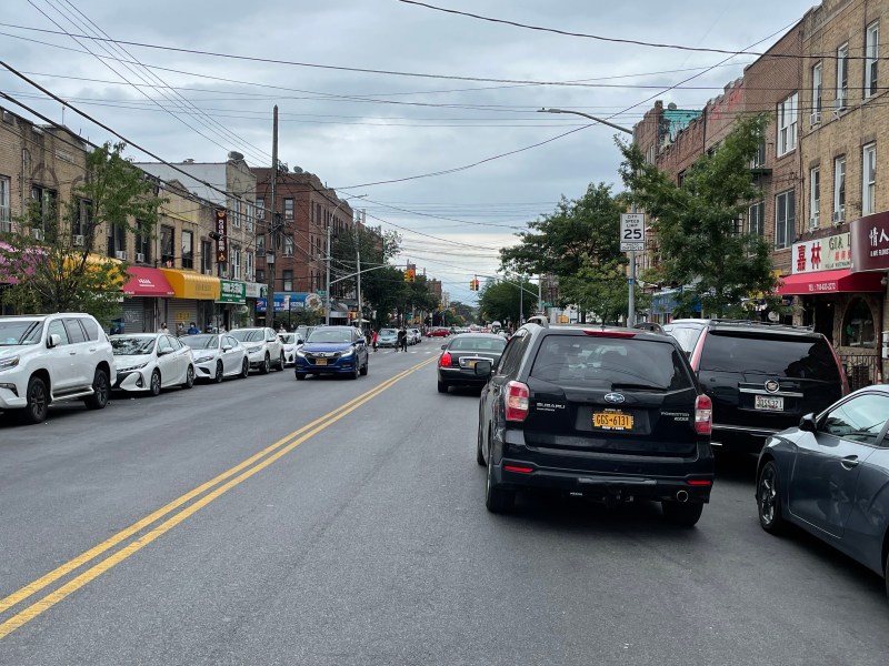 A double parked minivan in front of a double parked car on Eighth Avenue in Sunset Park. Photo: Dave Colon