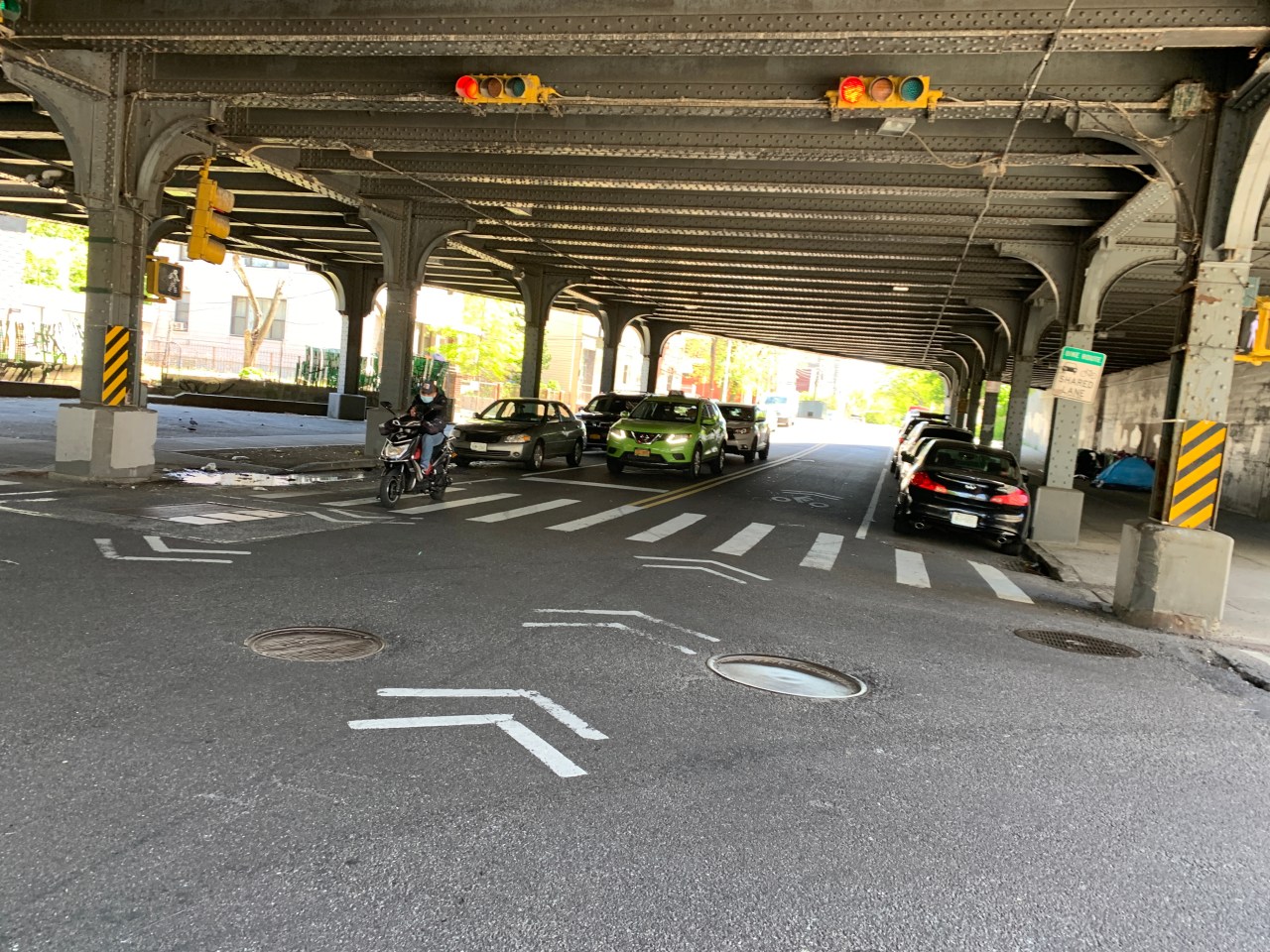 The most dangerous part of 39th Avenue — the LIRR trestle — is not covered by the DOT's plan. Removing just 10 parking spaces would make cyclists and drivers immeasurably safer through this narrow sluice. Photo: Gersh Kuntzman