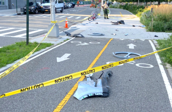 Police tape surrounds five city bike racks destroyed by a motorist Thursday morning in Long Island City. One of the six racks at the location apparently remained unscathed. Photo: Walking LIC Via Twitter
