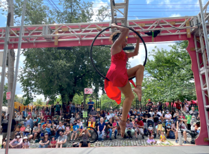 An acrobat performed on Sunday at the Bindlestiff Family Cirkus Flatbed Follies on 34th Avenue in Jackson Heights. Photo: 34th Avenue Open Street Coalition