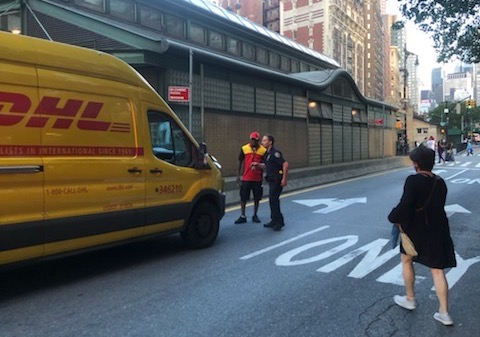 A cop talks to the suspect, who was later arrested. Photo: Liz Patek