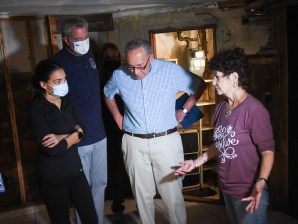 (from left) Alexandria Ocasio-Cortez, Mayor de Blasio and Sen. Chuck Schumer talk to a Queens flood victim. Photo: Michael Appleton / Mayoral Photography Office