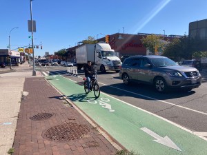 A biker riding in the new Northern Boulevard protected bike lane on Wednesday. Photo: Julianne Cuba