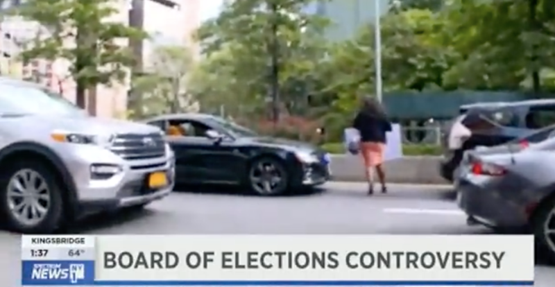 Here's the head of the Brooklyn Democratic Party fleeing a reporter by walking in the scrum of Flatbush Avenue. Photo: NY1