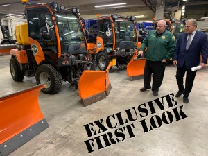 Sanitation Commissioner Ed Grayson (left with Deputy Commissioner Rocco DiRico) shows off the agency's new narrow snowplows. Photo: Gersh Kuntzman