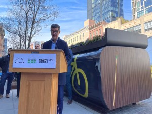 Department of Transportation Commissioner Ydanis Rodriguez standing in front of an Oonee mini bike parking pod. Photo: Dave Colon