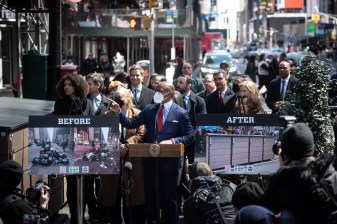 Mayor Adams pointed to the new trash enclosures installed by the Times Square Alliance under the Clean Curbs program at press conference on Wednesday. Photo: Mayor's Office