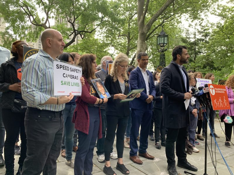 Transportation Alternatives' Danny Harris (with Assembly Member Harvey Epstein, far right) rallied for speed cameras. Photo: Gersh Kuntzman