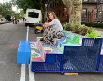 She stoops to conquer: A woman hangs out on the larger of the new 34th Avenue Open Street stoops. Photo: Gersh Kuntzman