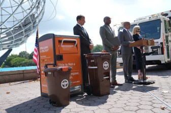 Mayor Adams stood next to a selection of Sanitation compost bins at the recent announcement that universal composting pickup will start in Queens. Photo: Mayor's Office