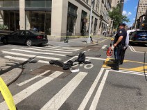 Police investigate after a driver hit a scooter rider in Downtown Manhattan on Wednesday. Photo: Julianne Cuba