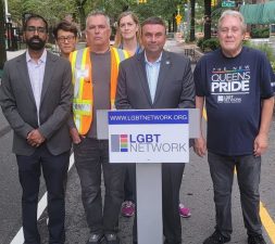 Jim Burke (third from left in reflective vest at Monday's press conference) said he was hit with homophobic slurs on the open street that he has helped make the city's best.