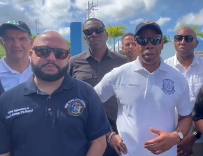 Mayor Adams (white shirt) was in Puerto Rico on Monday with (far left) DOT Commissioner Ydanis Rodriguez.