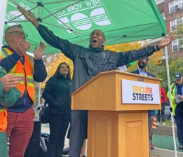 Queens Borough President Donovan Richards tries to quiet the hecklers on the 34th Avenue open street on Monday. Photo: Julianne Cuba