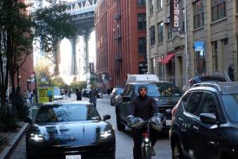 Pedestrians, cyclists, and drivers fend for space on DUMBO's much-photographed Washington Street. Photo: Kevin Duggan