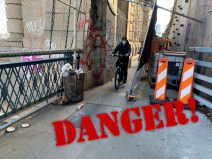 Coming through! Cyclists navigate the tight space left as stored construction block much of the bike path on the Manhattan Bridge. Photo: Gersh Kuntzman