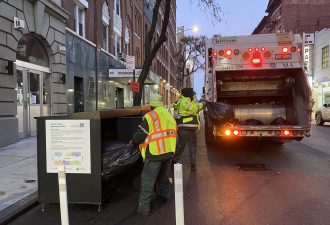 Historic haul: DSNY workers collect garbage from containers on W. 45th Street during the first day of the year-long residential Clean Curbs pilot on Dec. 13. Photo: Kevin Duggan