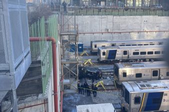 The driver of an SUV on Friday crashed into the concrete barrier and fell down onto the LIRR train tracks, killing one man and critically injuring a woman inside. Photo: Julianne Cuba