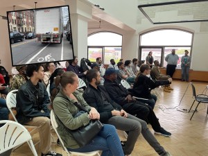Attendees of a community presentation of the Bedford Avenue protected bike lane on Thursday, a plan that hopes to eliminate dangers that come with painted lanes (inset). Main Photo: Dave Colon