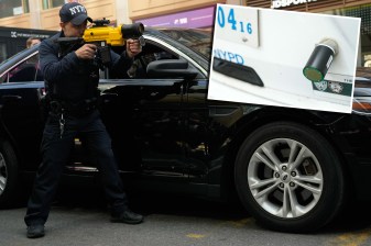 An NYPD officer shows off the StarChase technology, which the city says will reduce police chases. Photos: Michael Appleton / Mayoral Photography Office