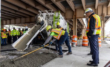 DOT Commissioner Ydanis Rodriguez watches workers filling in concrete at Meeker Avenue at a press event on April 18. Photo: DOT