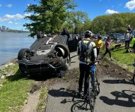 An 18-year-old driver flipped this BMW over the guardrails on the Henry Hudson Parkway on Saturday. Photo: Knoland via Reddit