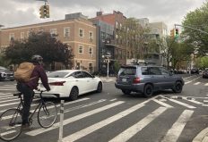 A cyclist crosses the intersection where Adam Uster was killed on Monday. Photo: Julianne Cuba