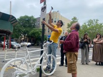 North Brooklynites at a June 3 rally installed a ghost bike and a sign to mark the intersection where cyclist Teddy Orzechowski, 73, was killed by a driver three weeks earlier. Photo: Kevin Duggan